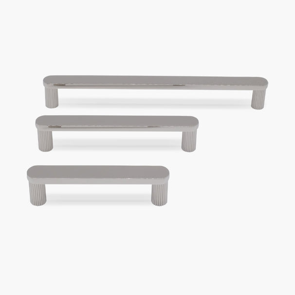 three ribbed polished nickel ribbed pulls in different sizes on white background