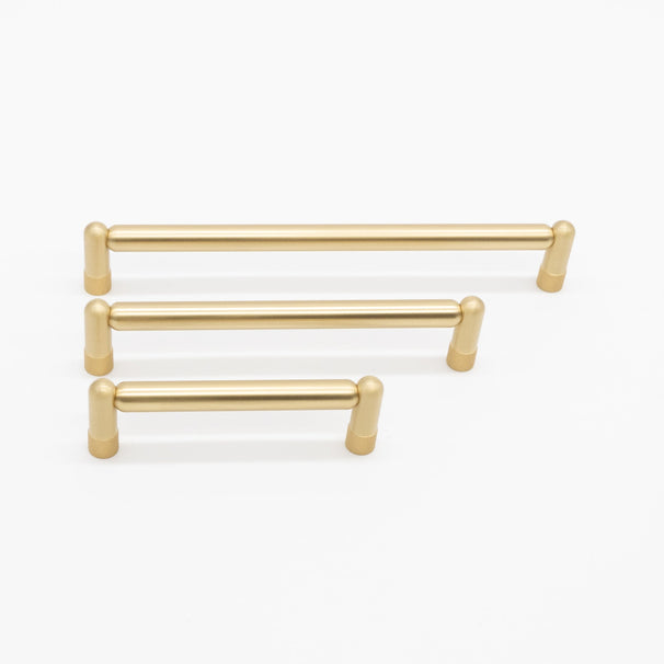 three sizes of knurled satin brass pulls on white background