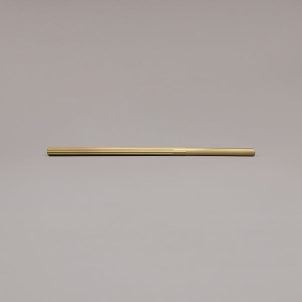18" Sunburst appliance pull in Satin Brass laying on gray background