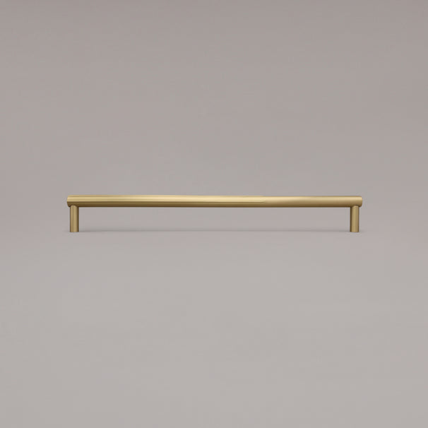 18" Sunburst appliance pull in Satin Brass standing on gray background