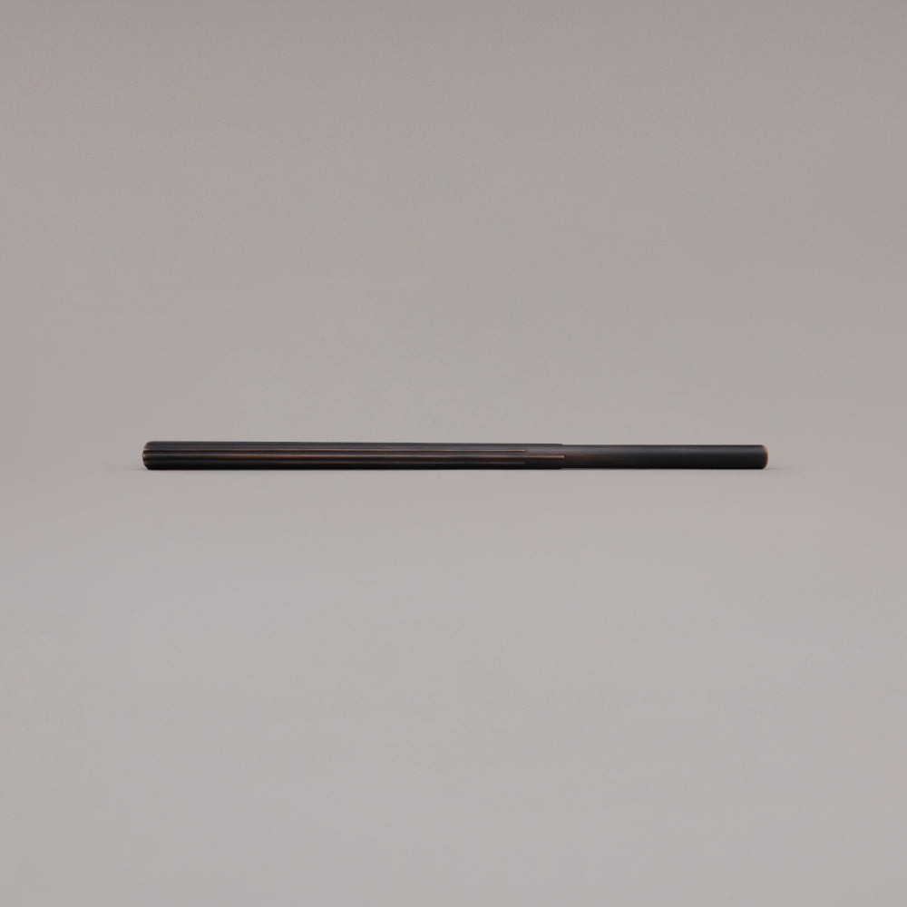 18" Sunburst appliance pull in Venetian Bronze laying on gray background