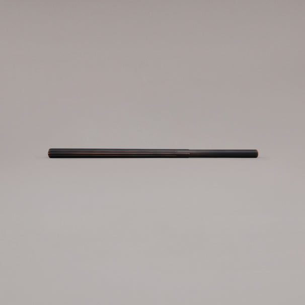 18" Sunburst appliance pull in Venetian Bronze laying on gray background