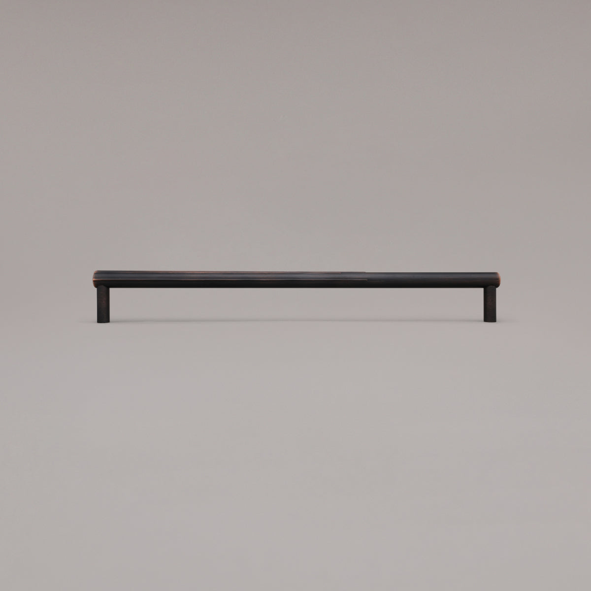 18" Sunburst appliance pull in Venetian Bronze standing on gray background