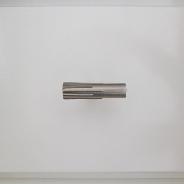 Satin nickel silver t-knob installed horizontally on a white bathroom cabinet 