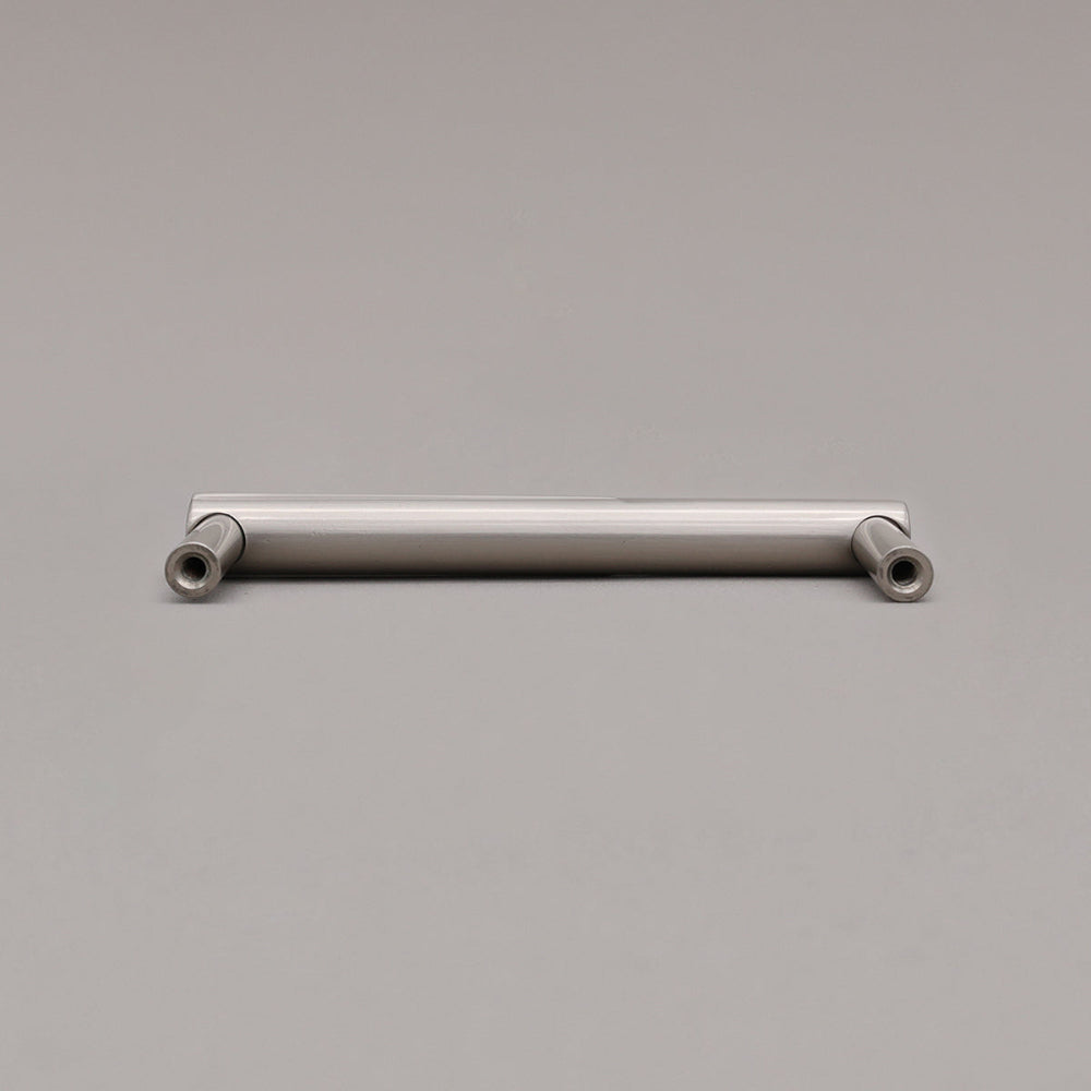 rear view of small silver satin nickel sunburst cabinet pull on gray background