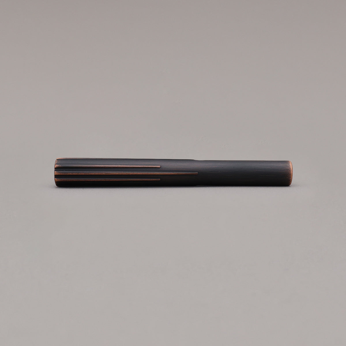 small venetian bronze sunburst pull laying on gray background