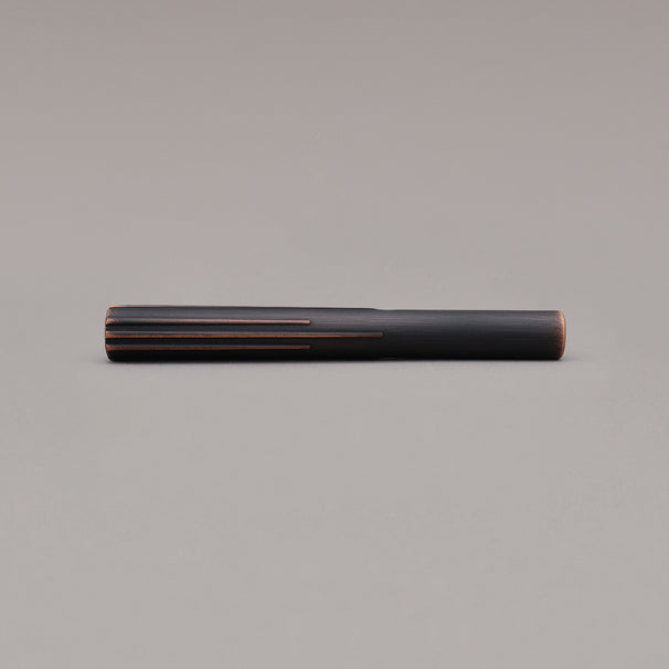 small venetian bronze sunburst pull laying on gray background