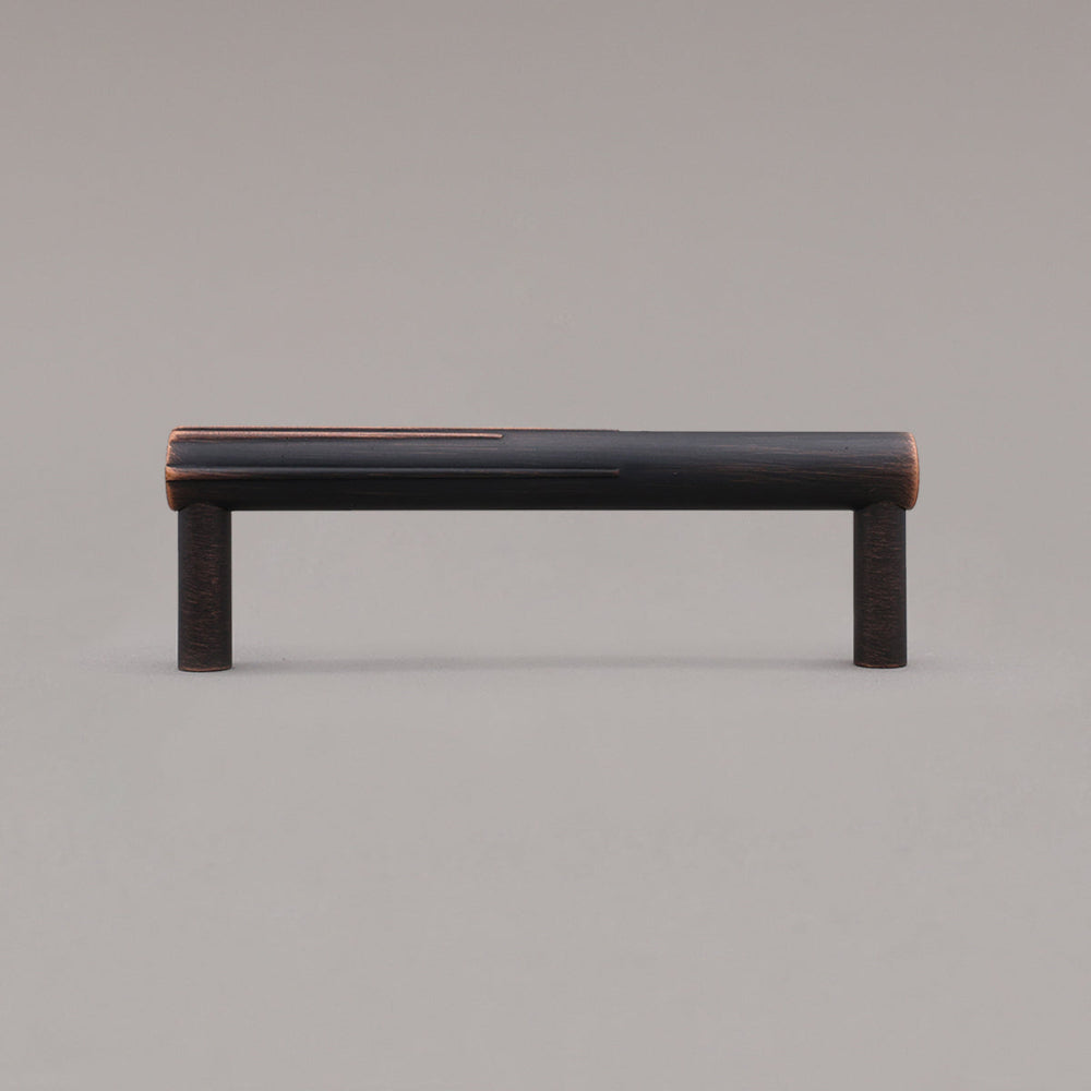 small venetian bronze sunburst cabinet pull standing on gray background