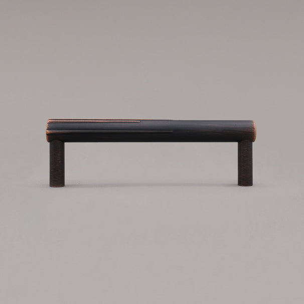 small venetian bronze sunburst cabinet pull standing on gray background