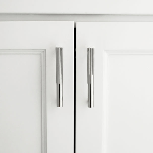 sunburst polished nickel cabinet pulls installed on white cabinet