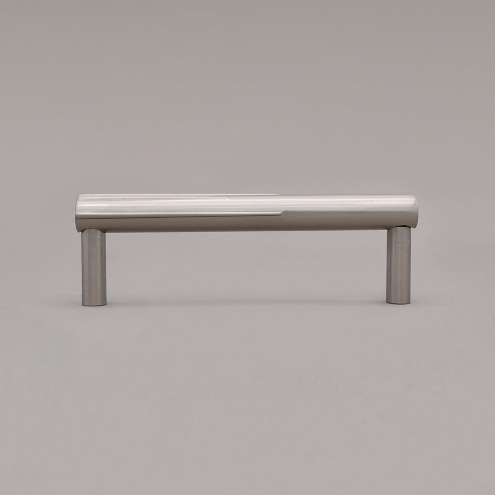 small silver satin nickel sunburst cabinet pull standing on gray background