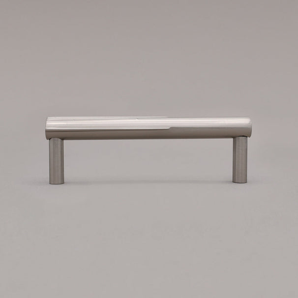 small silver satin nickel sunburst cabinet pull standing on gray background