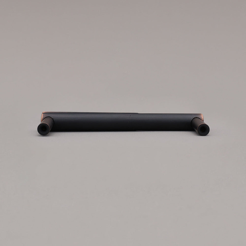 Rear view of small venetian bronze sunburst cabinet pull on gray background