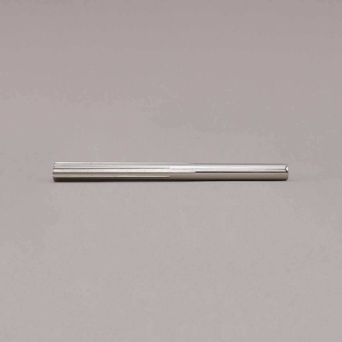 medium polished nickel sunburst pull laying on gray background