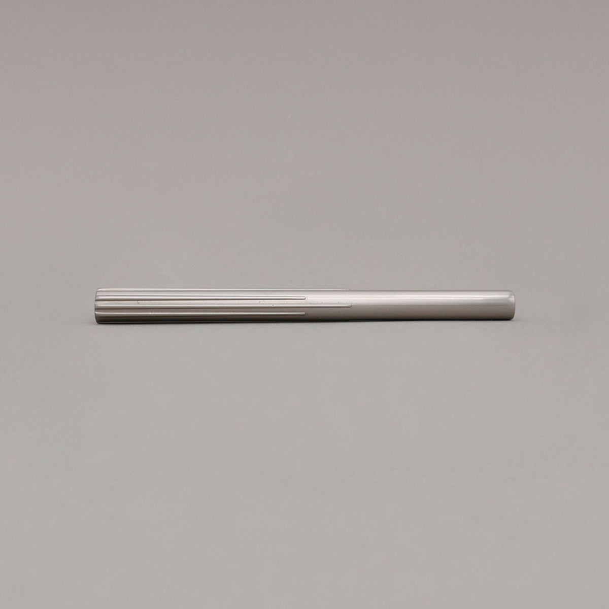 medium satin nickel sunburst pull laying on gray background