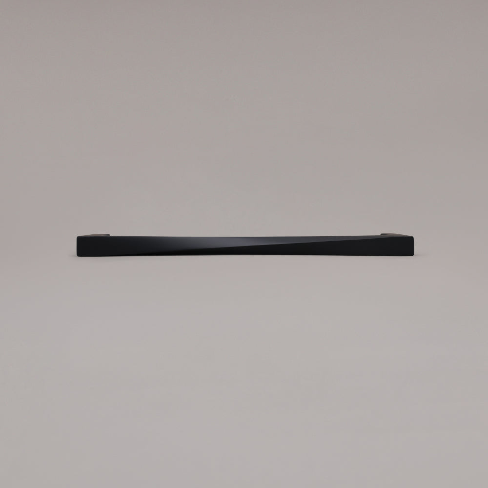 12" Twist appliance pull in Matte Black laying on gray background