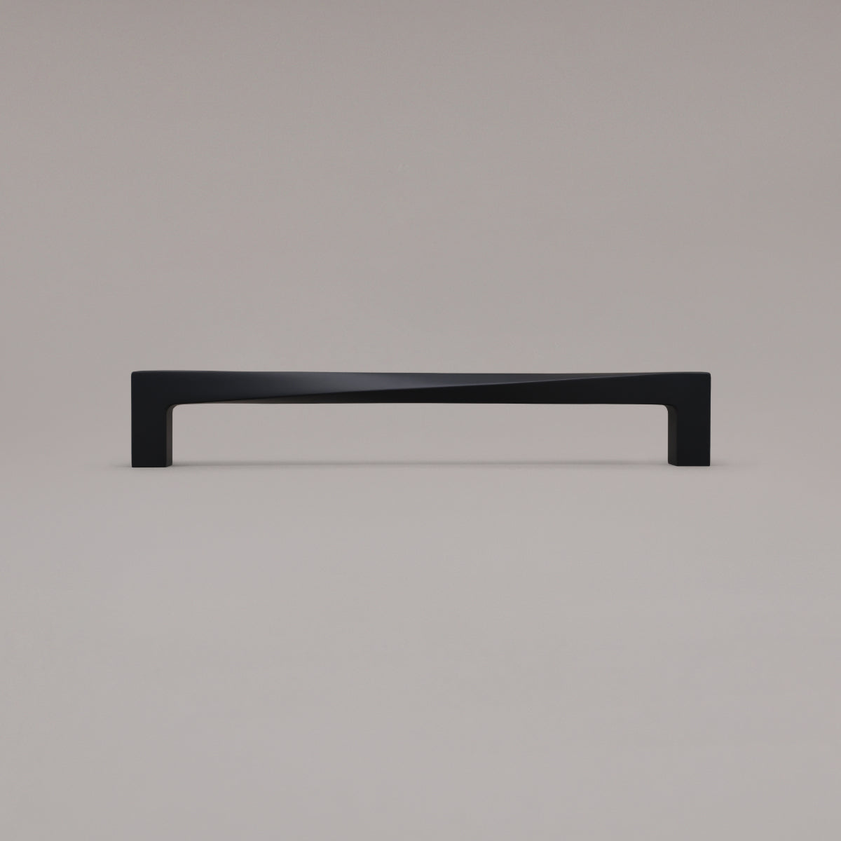 12" twist appliance pull in matte black standing on gray background