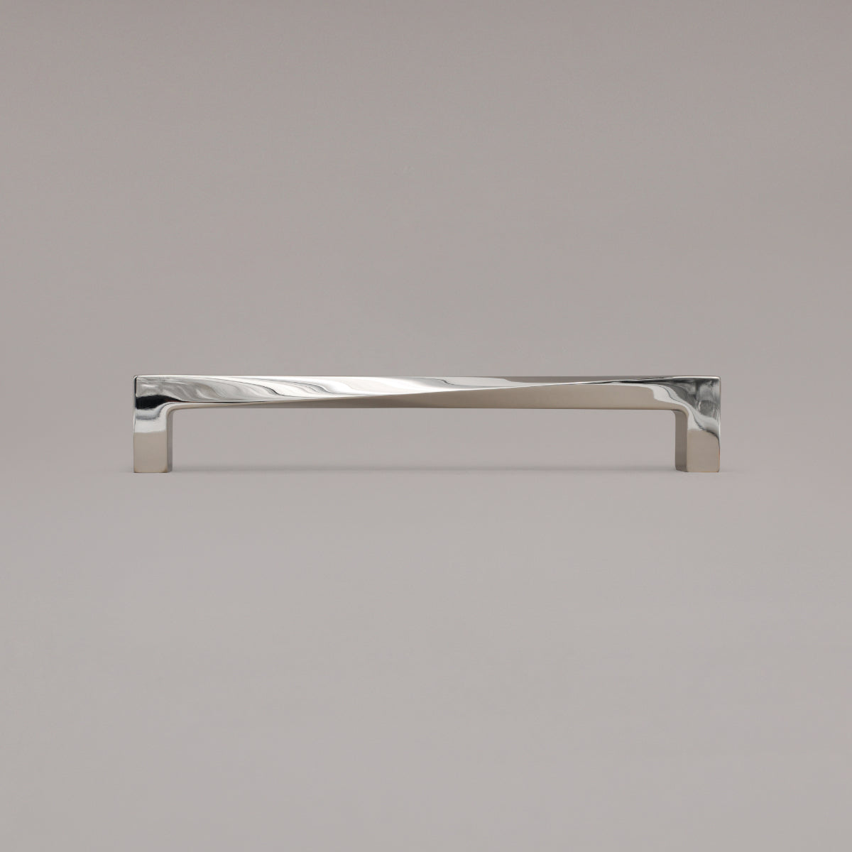 12" twist appliance pull in polished nickel standing on gray background