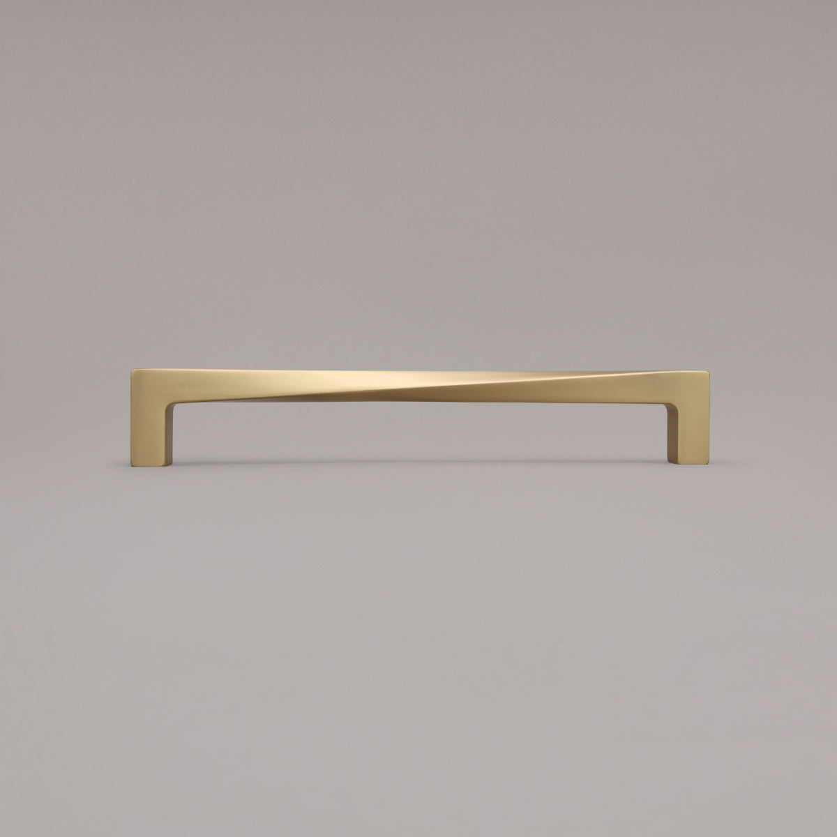 12" twist appliance pull in satin brass standing on gray background