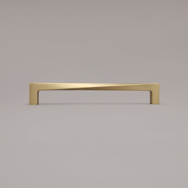 12" twist appliance pull in satin brass standing on gray background