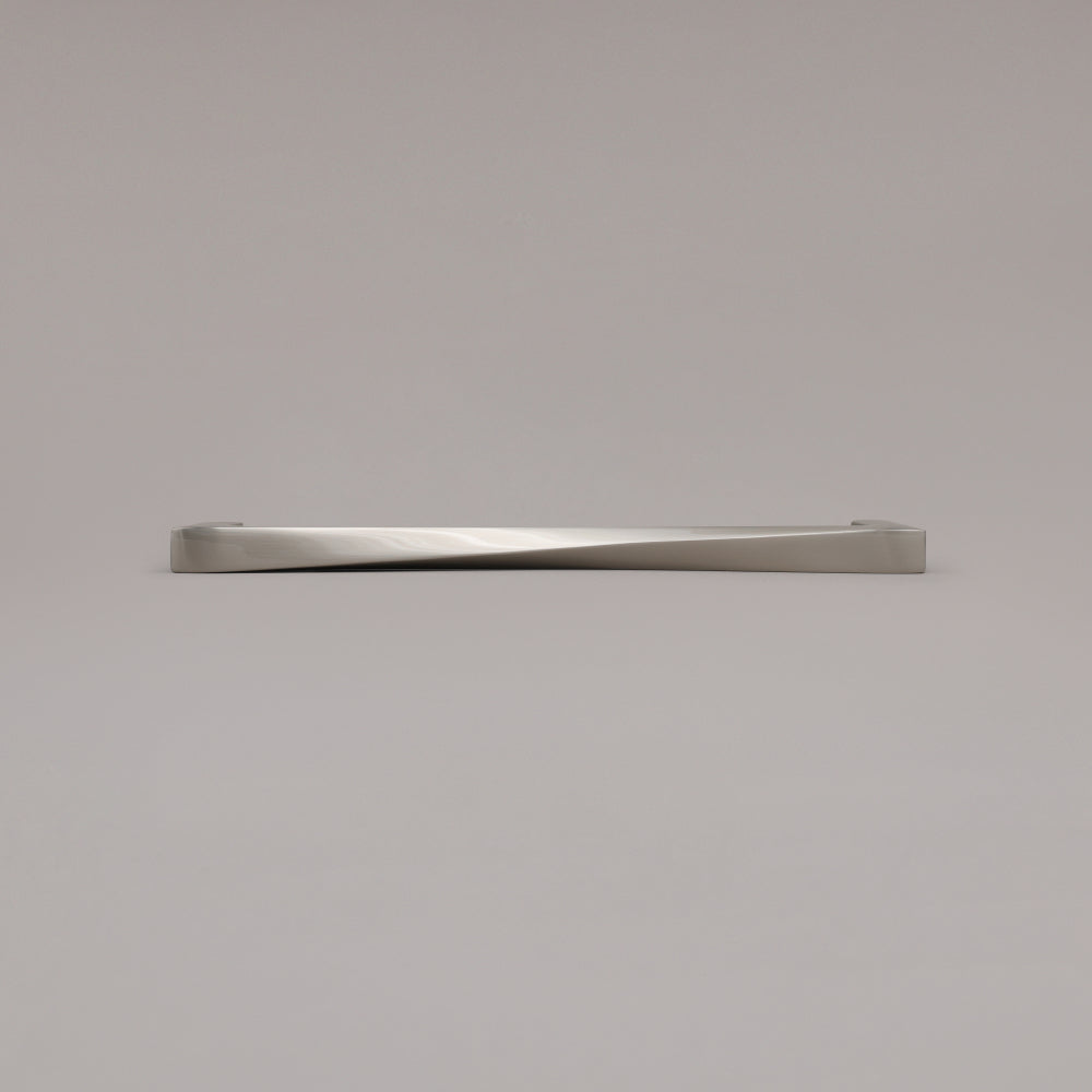12" Twist appliance pull in Satin Nickel laying on gray background