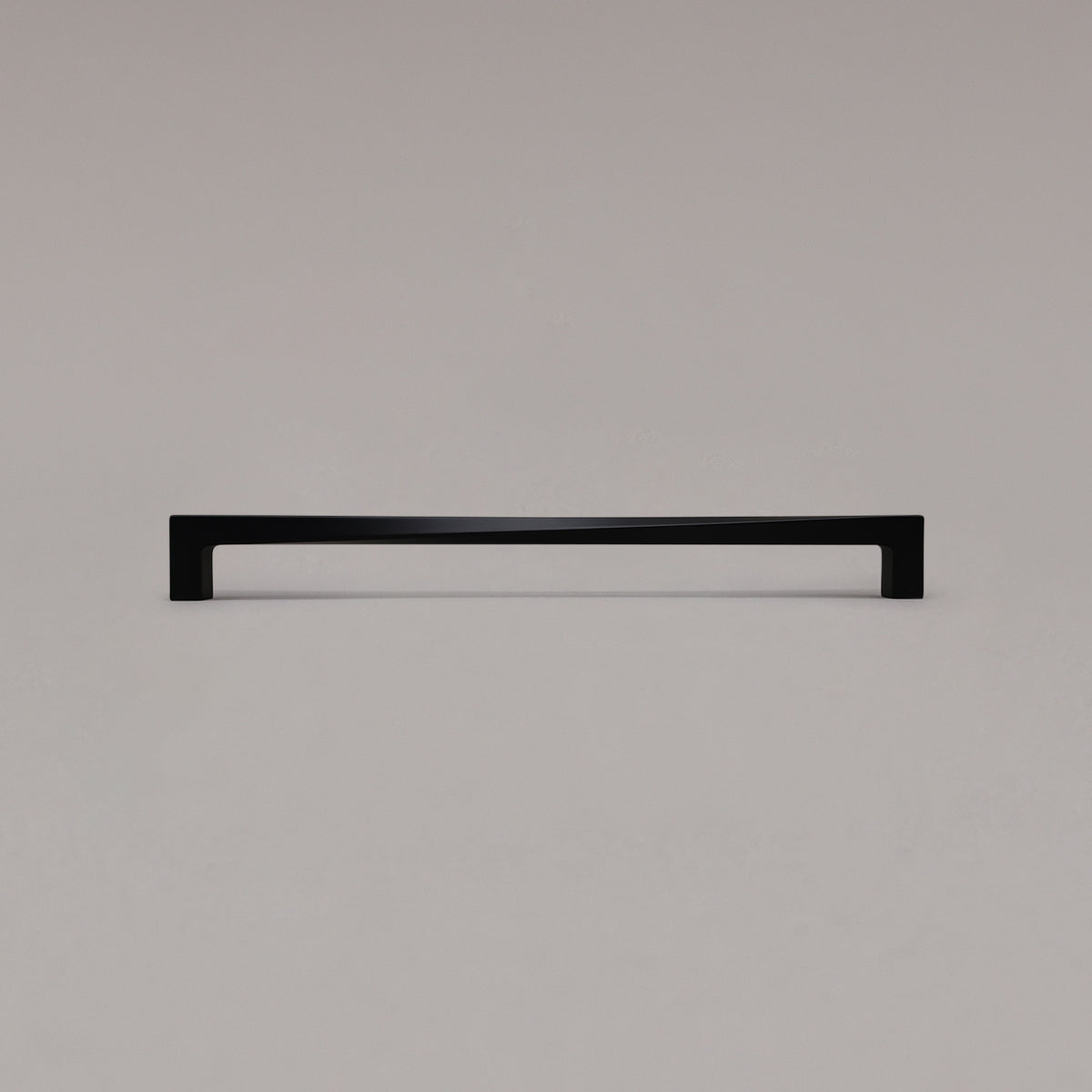 18" twist appliance pull in matte black standing on gray background