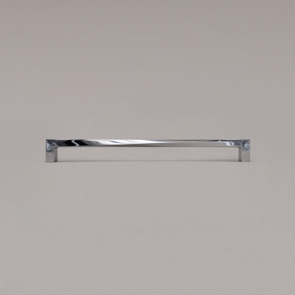 18" twist appliance pull in polished chrome standing on gray background
