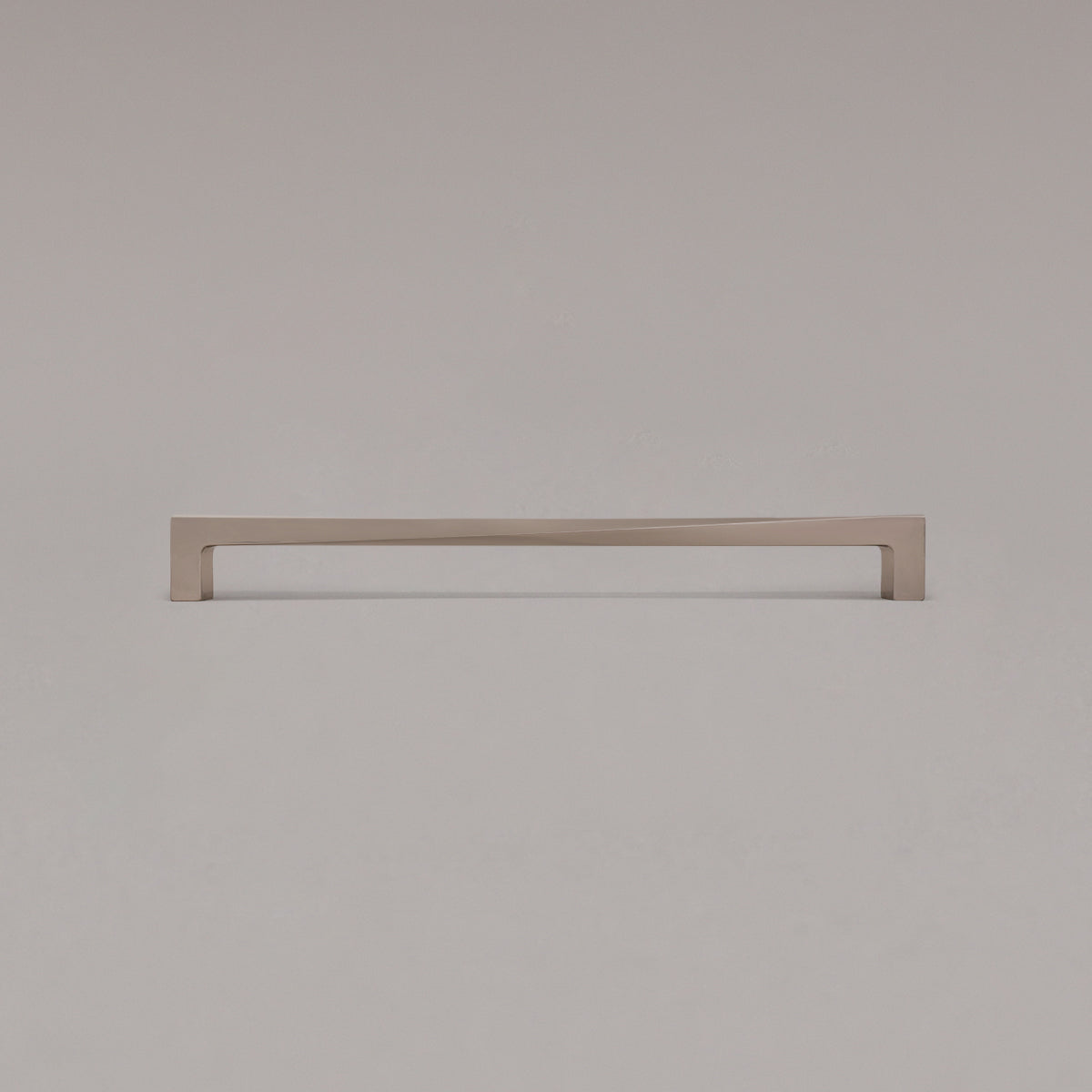 18" twist appliance pull in polished nickel standing on gray background