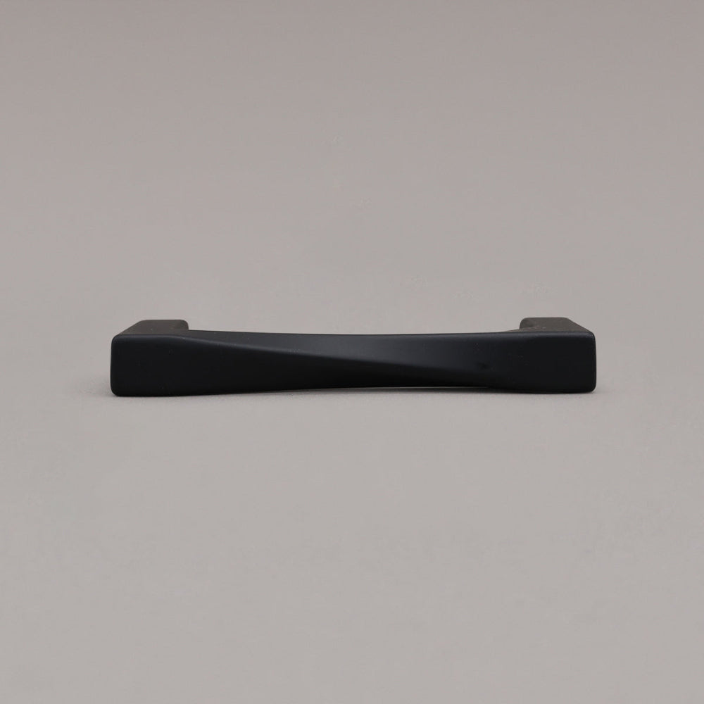 small matte black twist pull laying down on gray background
