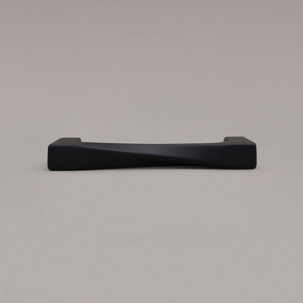 small matte black twist pull laying down on gray background