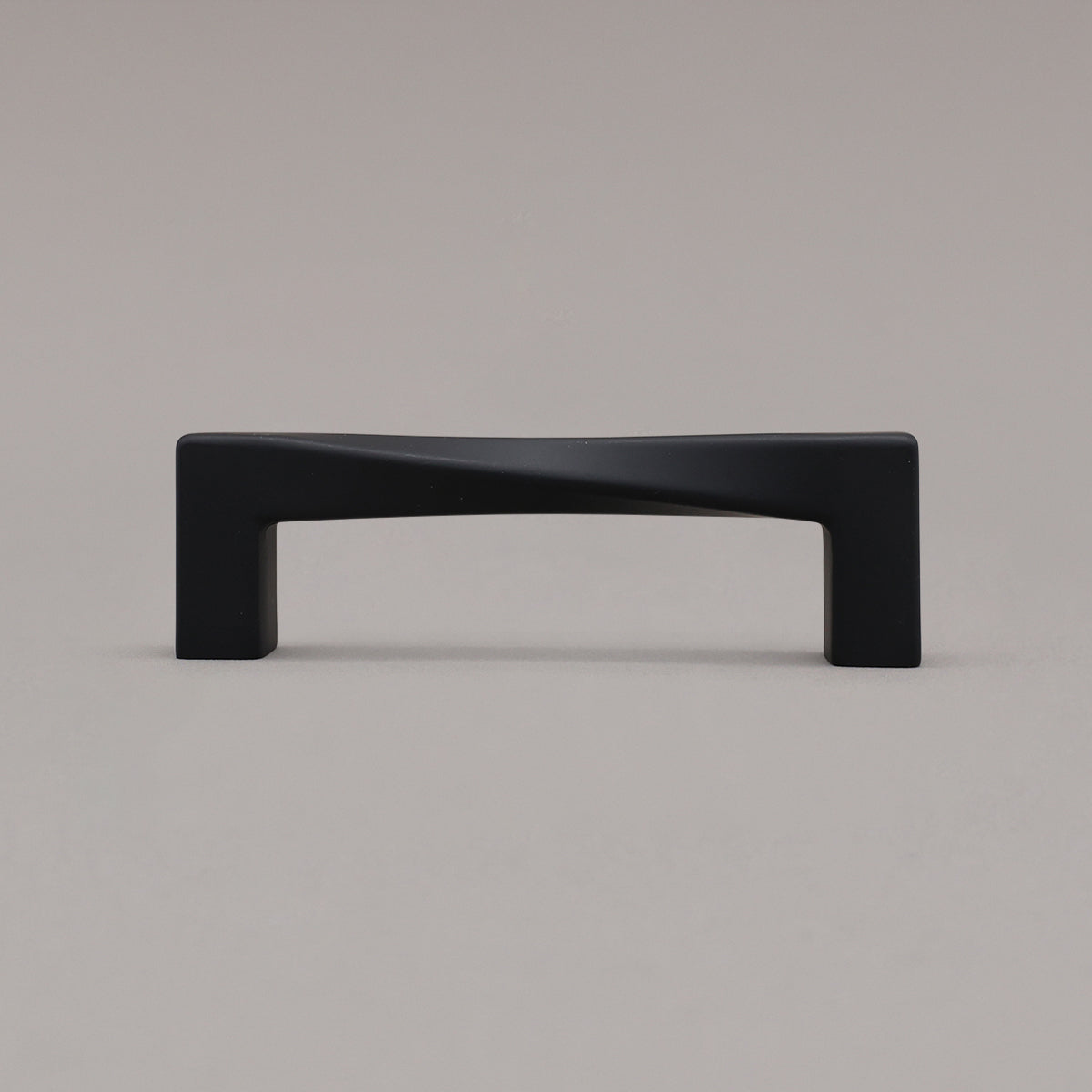 Small matte black twist pull standing on gray background