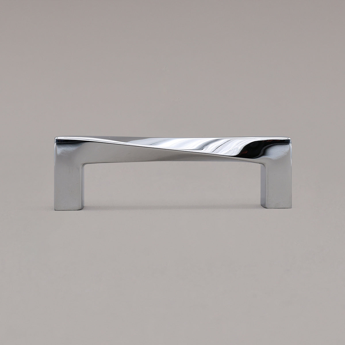 Small polished chrome twist pull standing on gray background