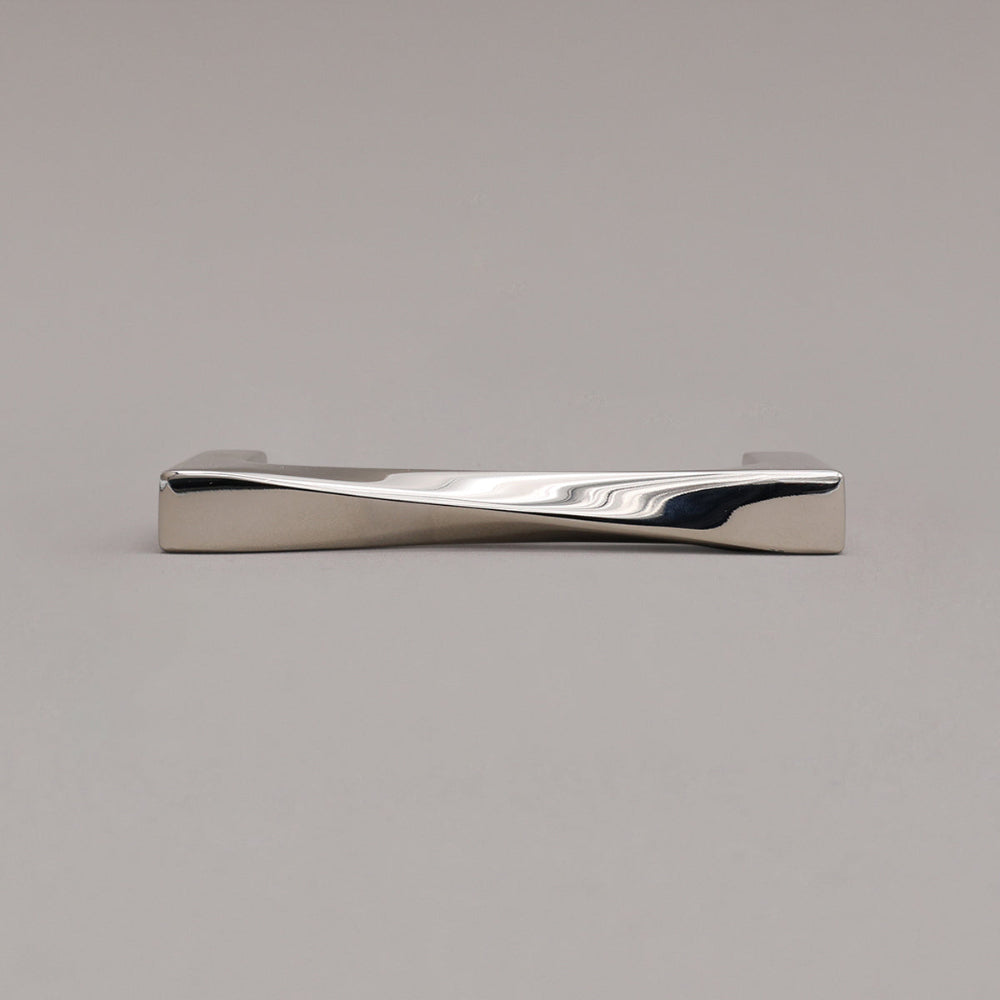small twist polished nickel pull laying on gray background