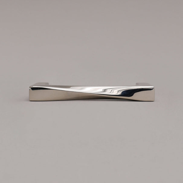 small twist polished nickel pull laying on gray background