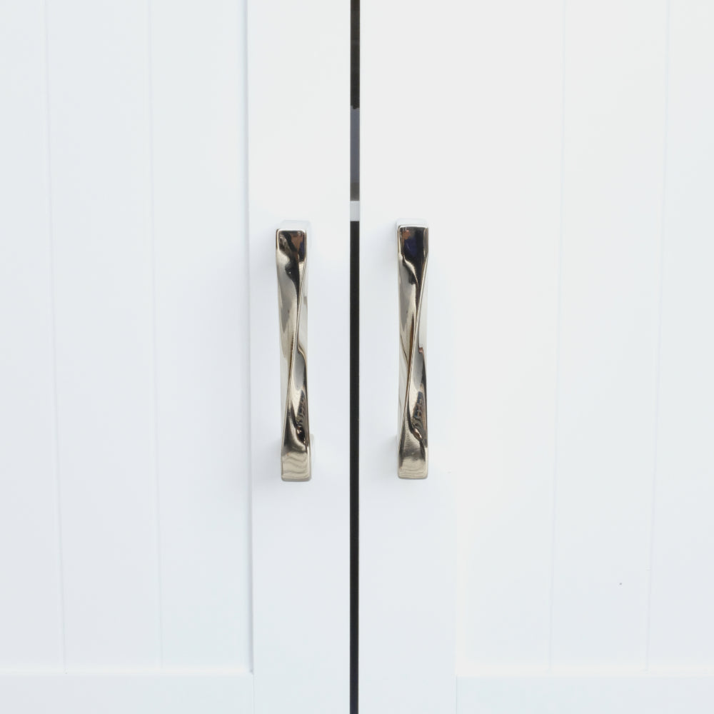 twist polished nickel cabinet pulls installed on white cabinet