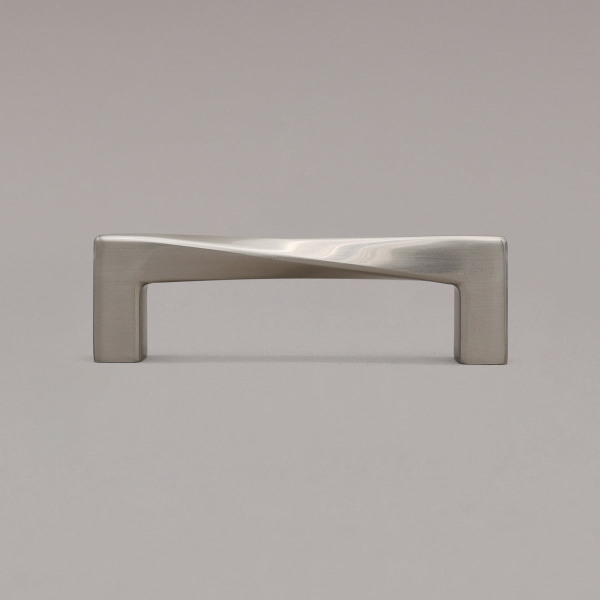 Small satin nickel silver twist pull standing on gray background