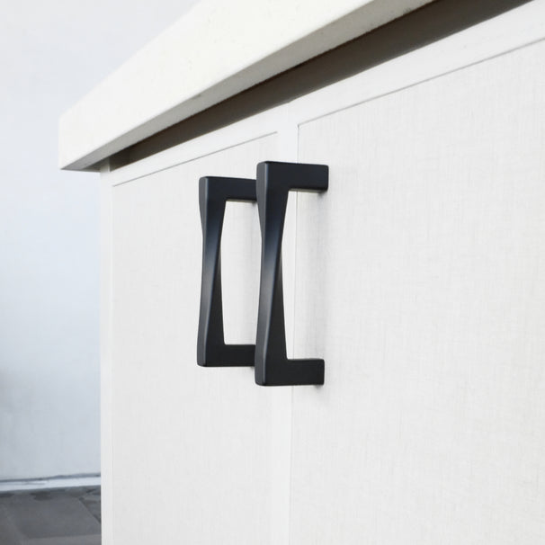 twist matte black cabinet pulls installed on neutral light cabinets
