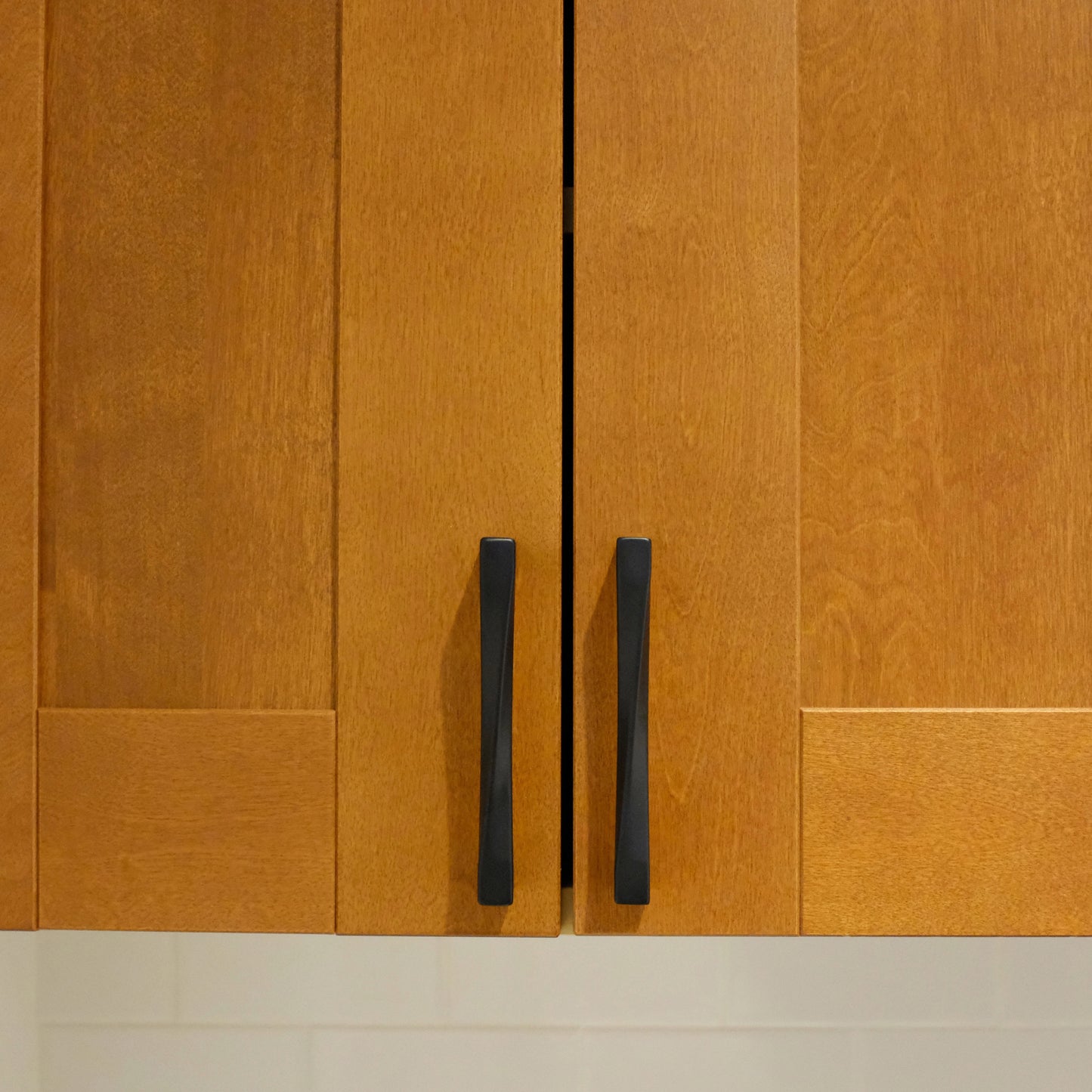 Twist matte black pulls installed on wooden cabinet