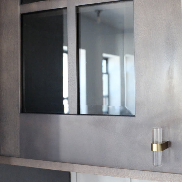 clear Acrylic and gold cabinet knob on black kitchen cabinet.