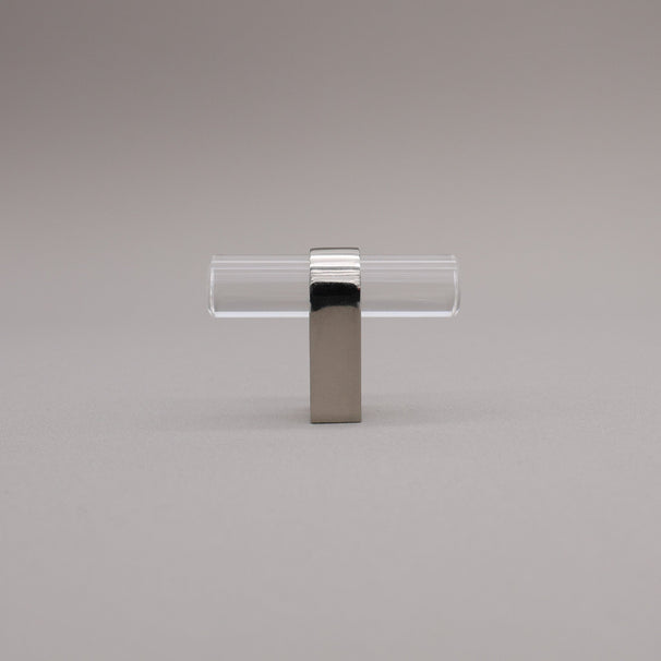 Clear acrylic and polished nickel stem knob on gray background
