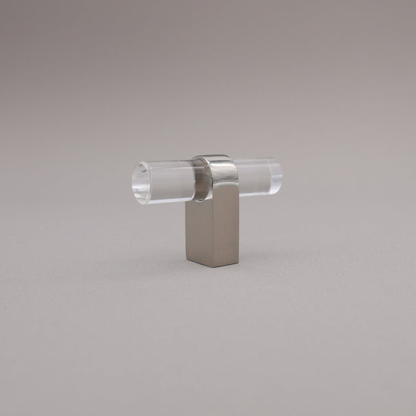 Polished nickel and acrylic knob against a gray background