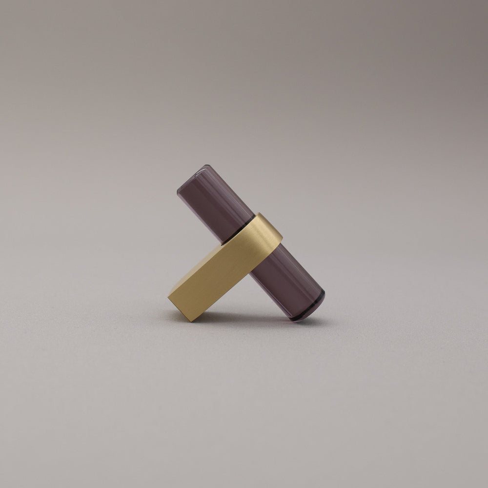 smoke acrylic and satin brass stem knob on gray background