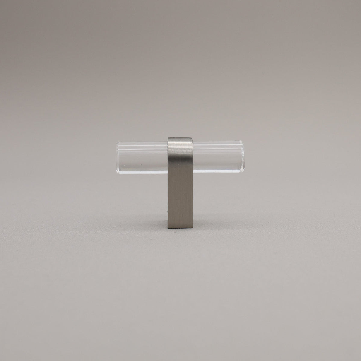 Clear acrylic and satin nickel stem knob on gray background