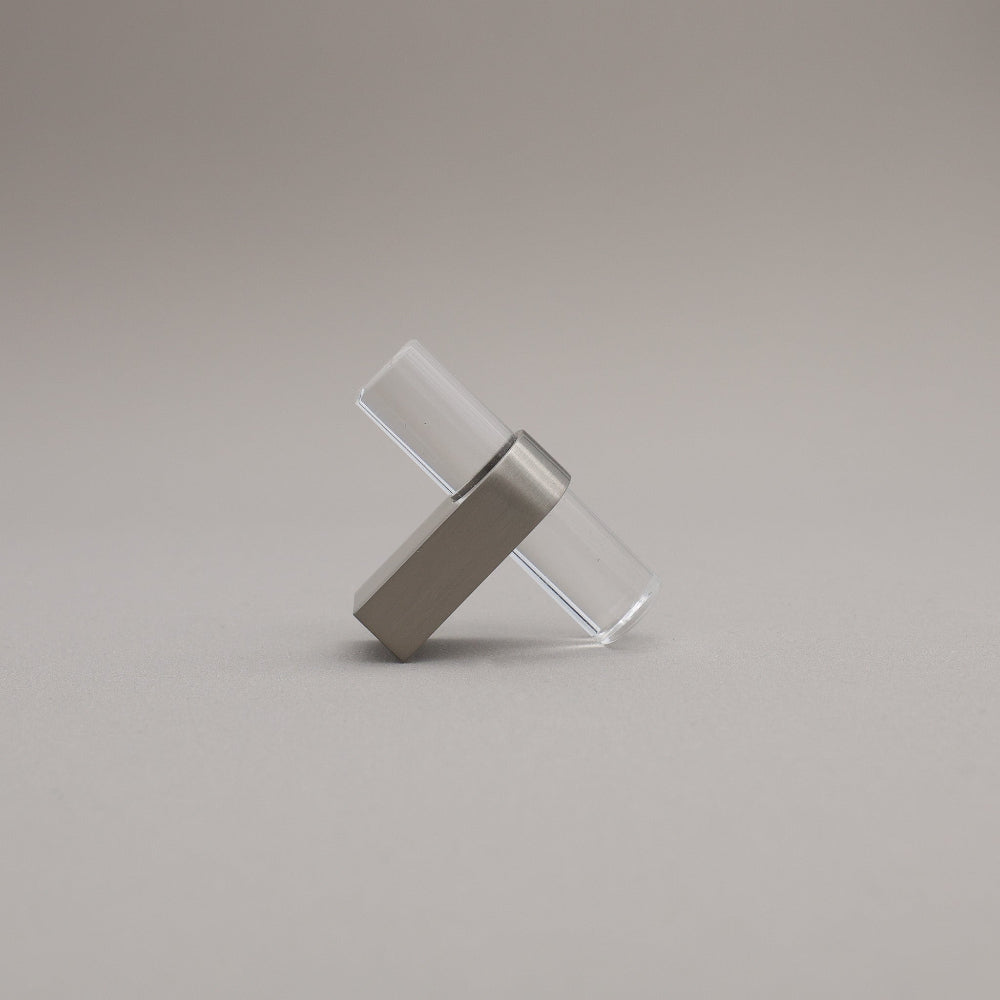 Clear acrylic and satin nickel stem knob on gray background