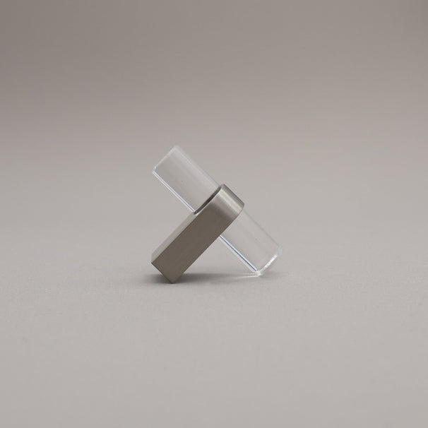 Clear acrylic and satin nickel stem knob on gray background