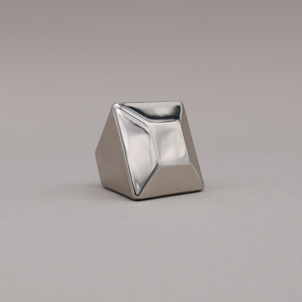 polished nickel geometric diamond knob on a gray background