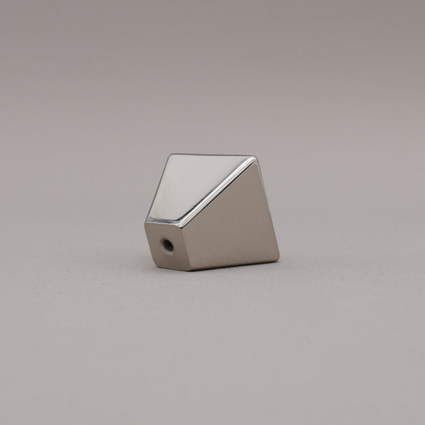 polished nickel geometric diamond knob on a gray background