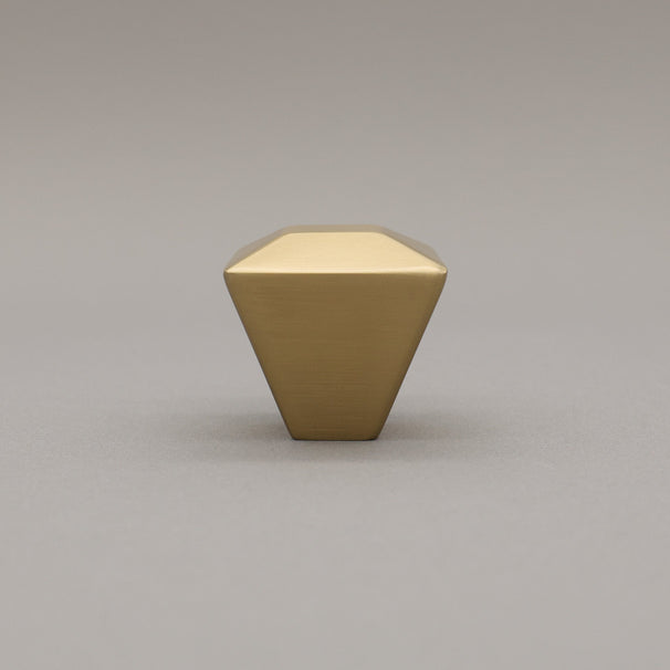 satin brass gold geometric diamond knob on a gray background standing