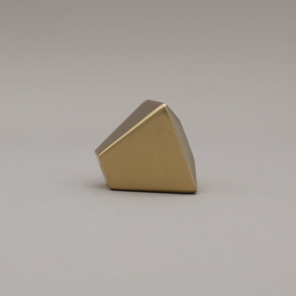 satin brass gold geometric diamond knob on a gray background side view