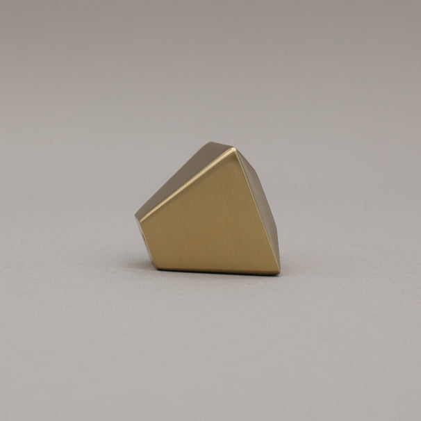 satin brass gold geometric diamond knob on a gray background side view